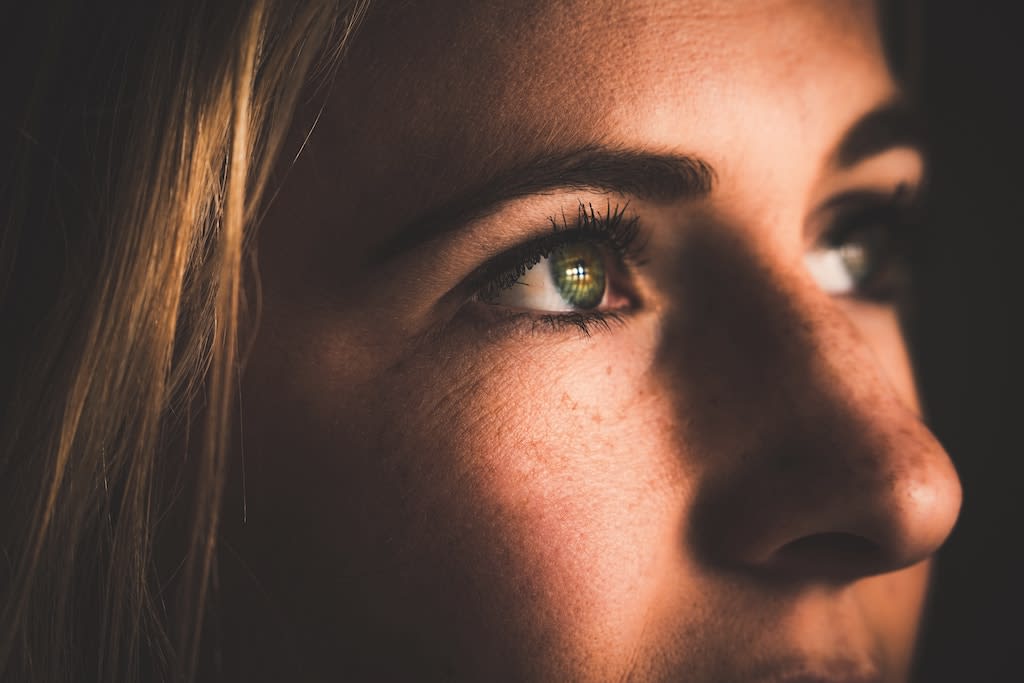 A close up of a woman looking up.